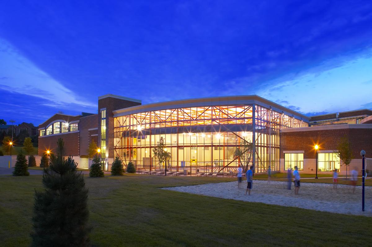 ${ The exterior of the south side of the RecPlex - including the aquatic center and the sand volleyball court - at night }